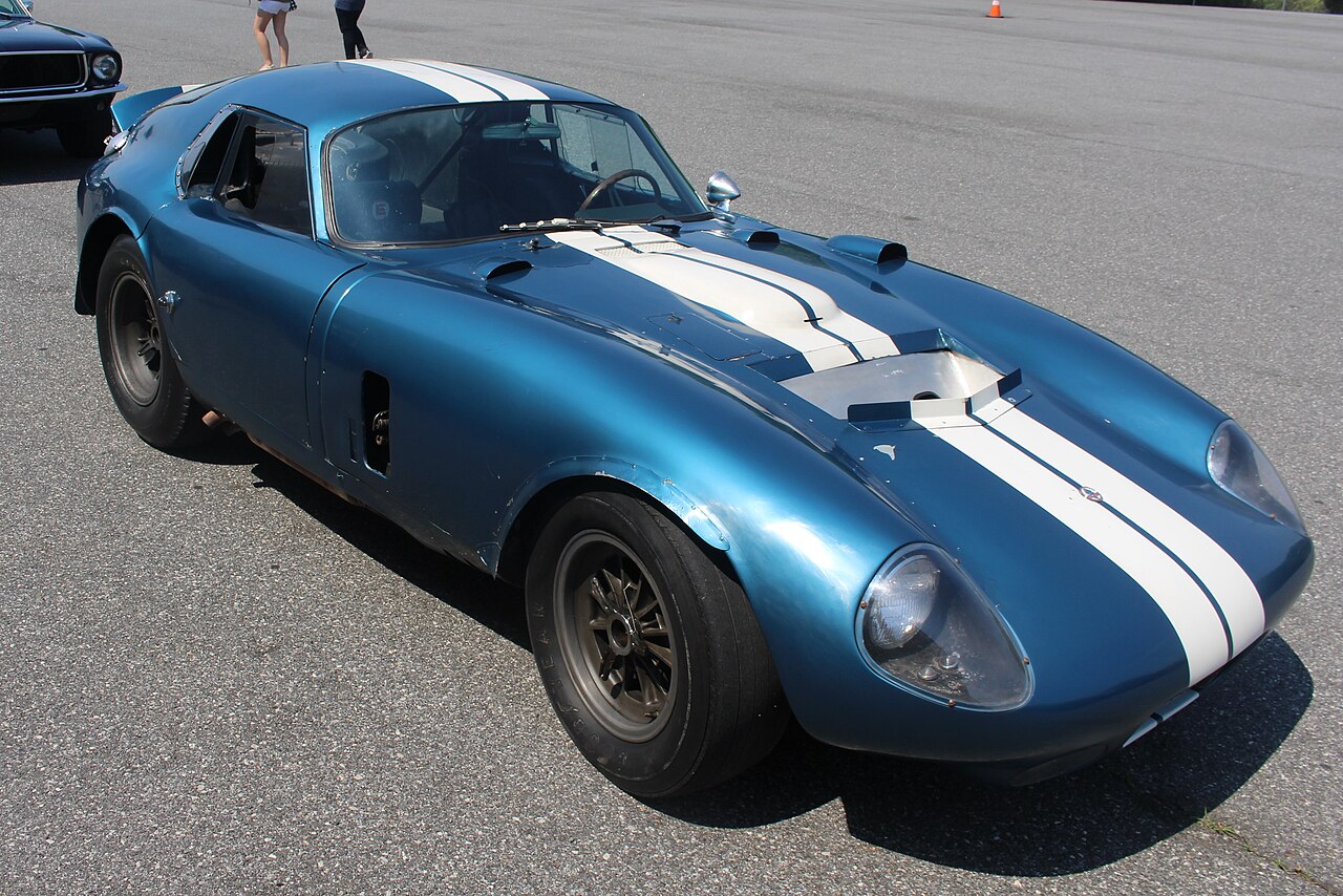 Front-left view of the actual blue-and-white Shelby Cobra Daytona Coupe prototype CSX2287 in preserved, partially restored form; no registration is visible.