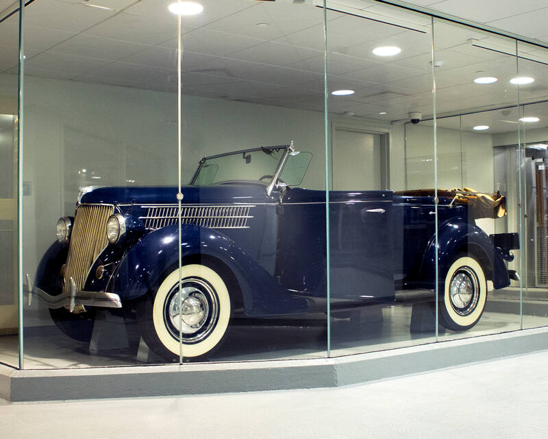 Blue 1936 Ford Phaeton used by Eleanor Roosevelt, displayed behind glass at the FDR Library and Museum.