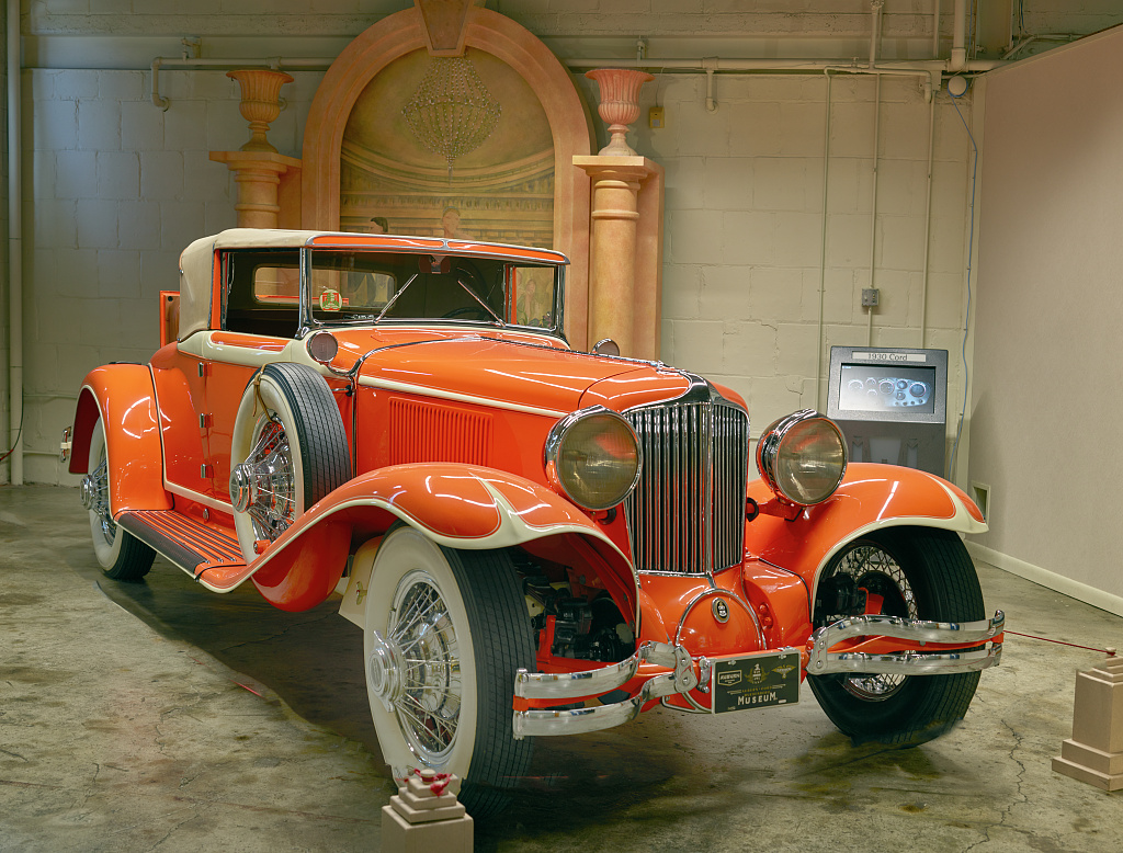 Bright orange 1930 Cord L-29 Cabriolet displayed indoors at the Auburn Cord Duesenberg Automobile Museum in 2016.