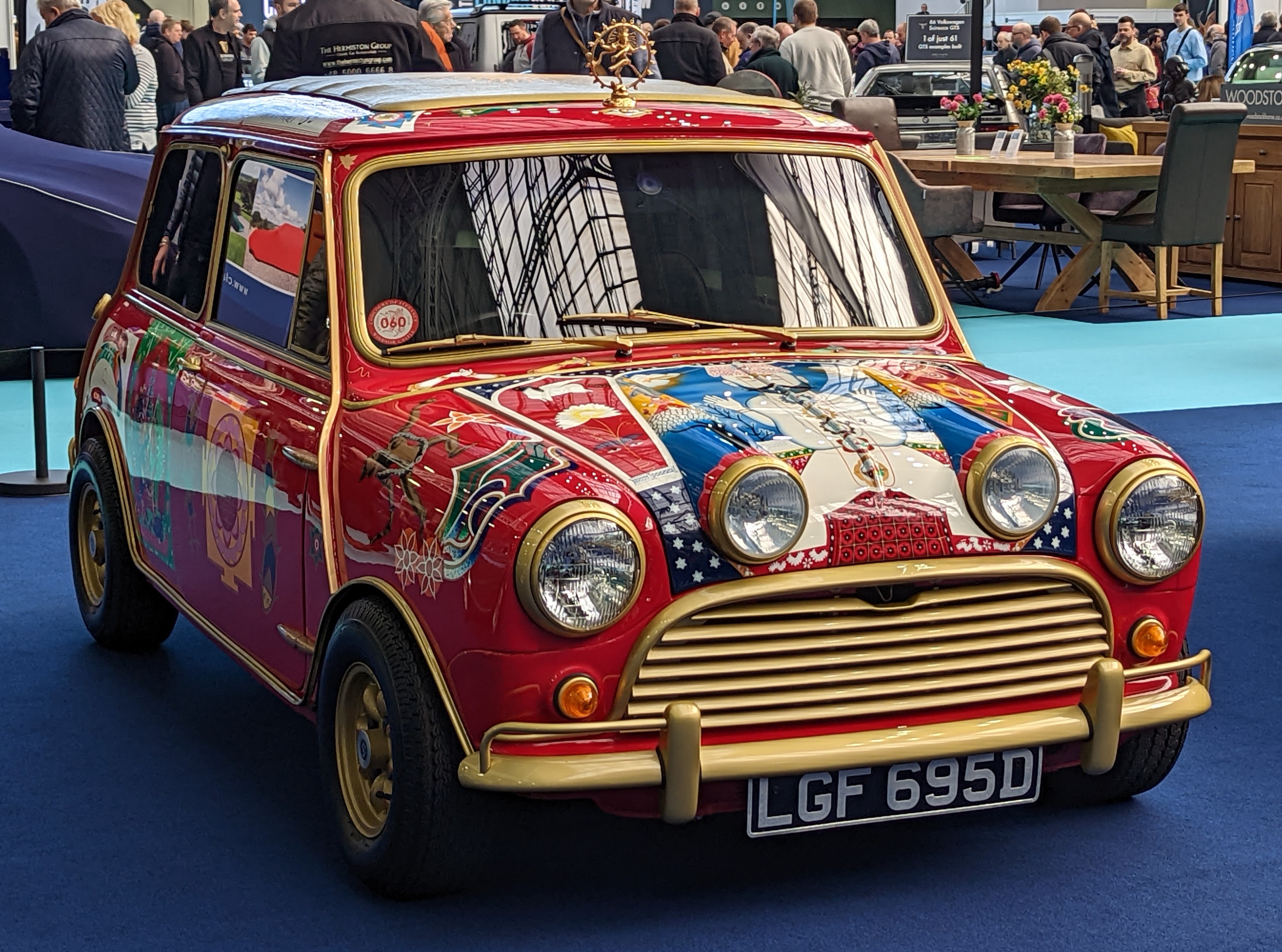 George Harrison’s red and gold psychedelic Radford Mini de Ville displayed indoors at the 2023 London Classic Car Show.
