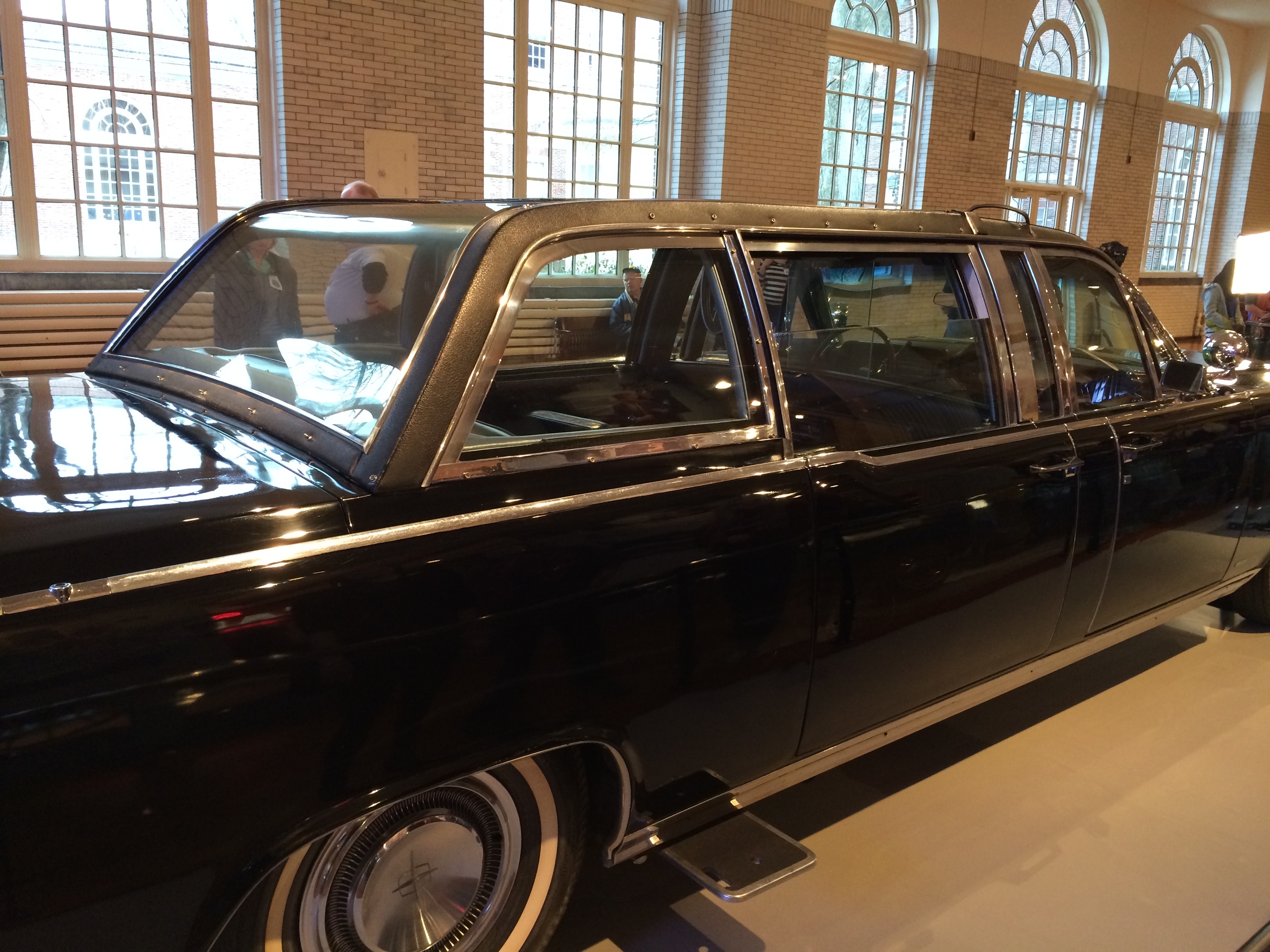 Side view of John F. Kennedy’s actual 1961 presidential Lincoln limousine displayed in its later black armored form at The Henry Ford; no registration is visible.