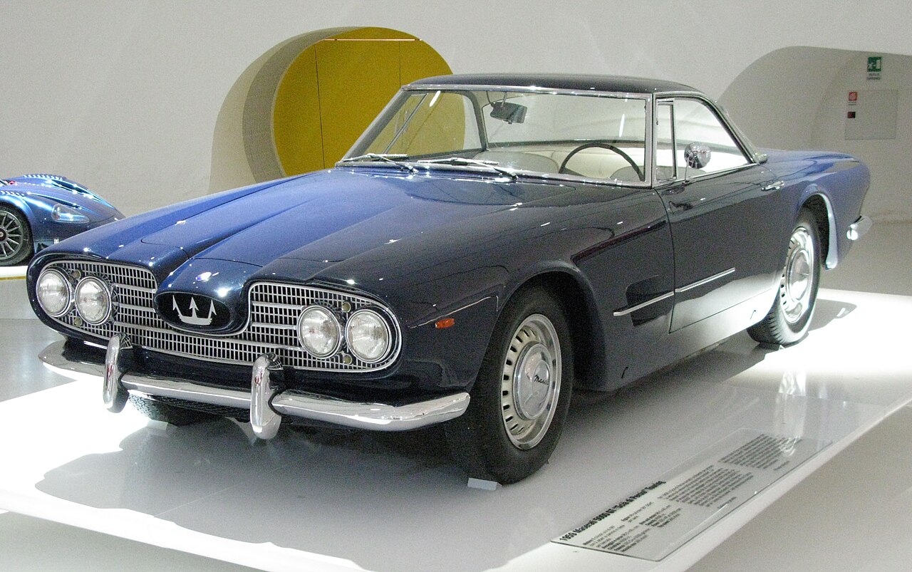 Dark blue 1959 Maserati 5000 GT Shah of Persia, chassis AM103.002, displayed indoors at Museo Enzo Ferrari in 2014.