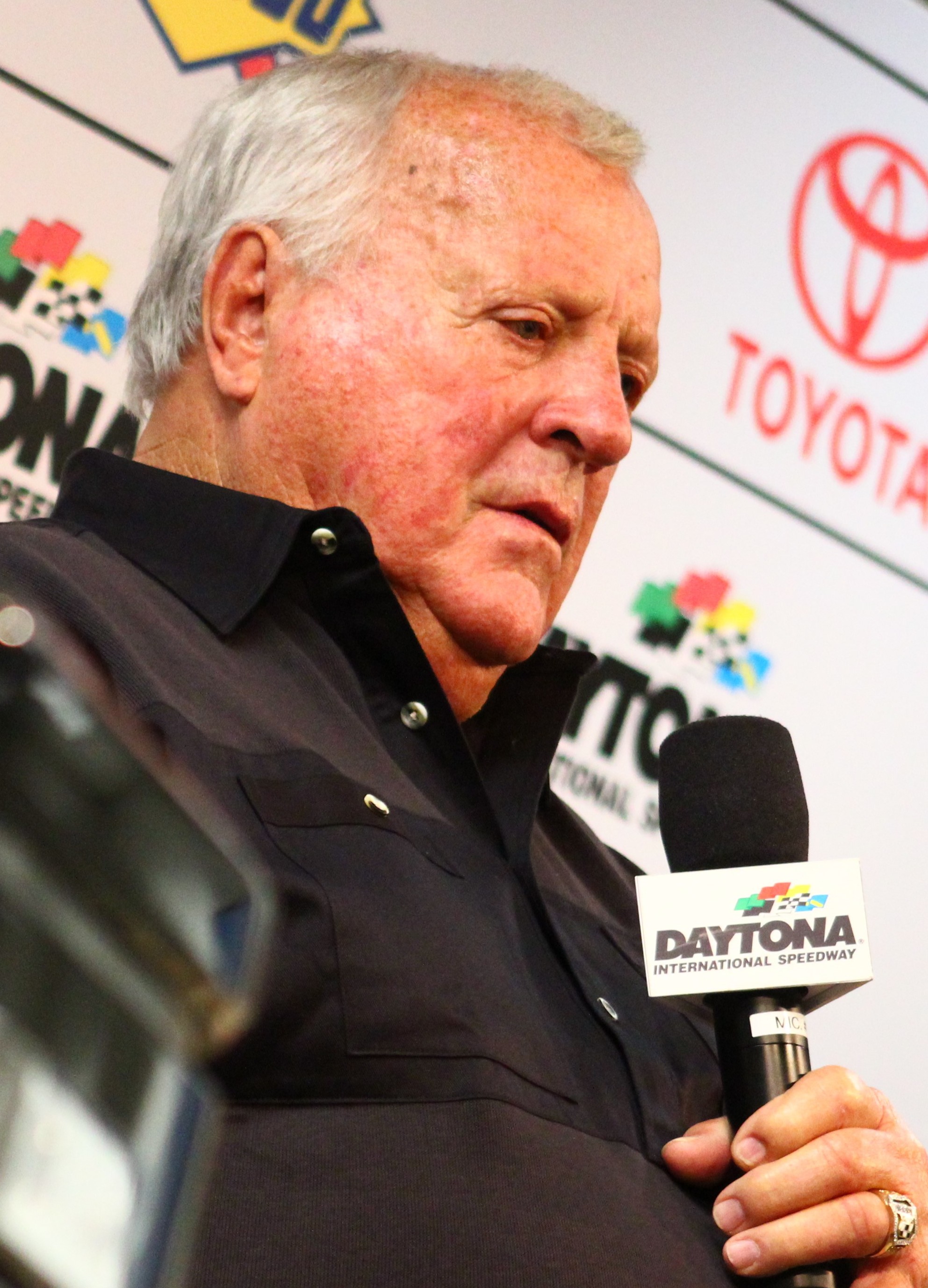 A.J. Foyt speaking into a microphone at the 2019 Daytona 500.