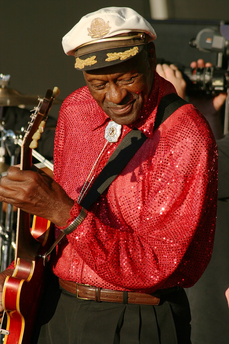 Chuck Berry performing in a red sequined shirt and white captain’s hat at Virgin Festival in 2008, photographed by Joe Cereghino.