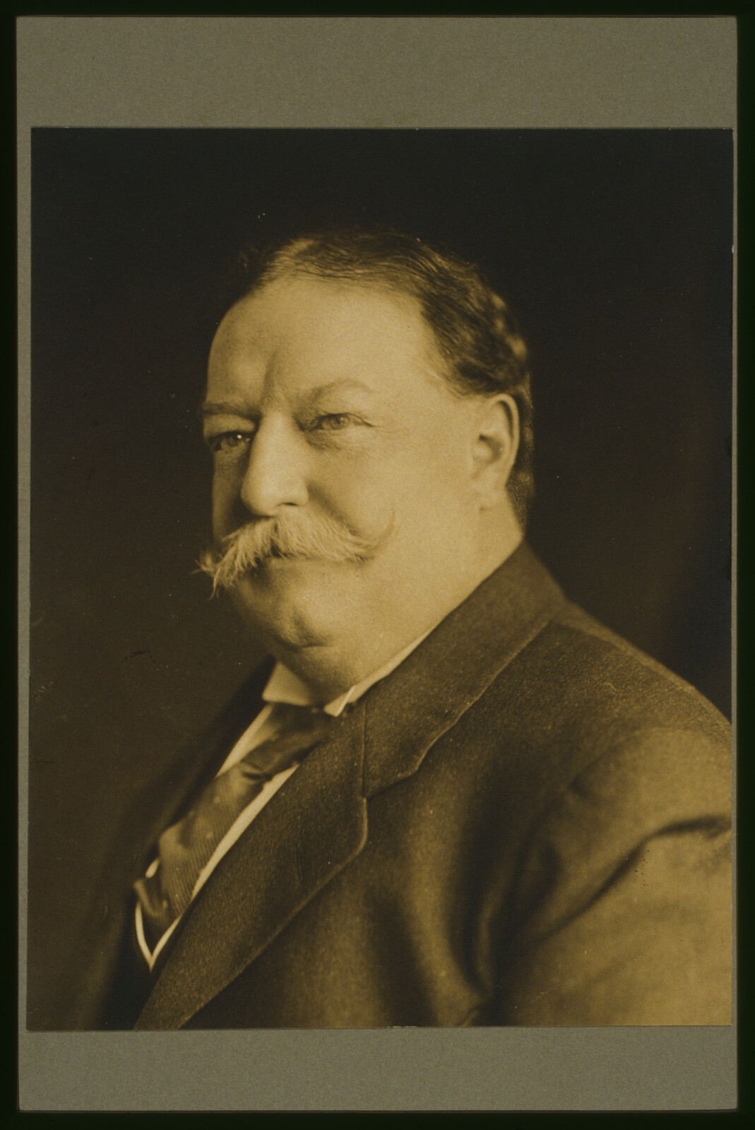 Sepia-toned 1909 head-and-shoulders identification portrait of William Howard Taft facing slightly left.